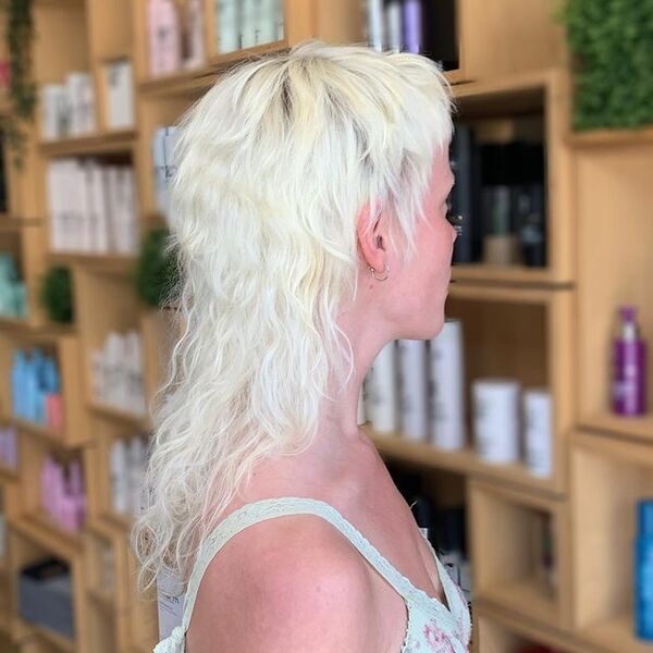 Blonde Curly Mullet Hairstyle - a woman in a back view
