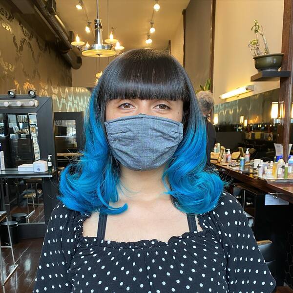 Blunt Bangs with Blue Hairstyle - a woman wearing a face mask
