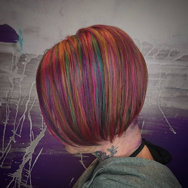 Bob Cut Rainbow Bright Hair - A woman with tattoo wearing a gray jacket