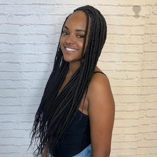 Box Braids Natural Hairstyles for Women- a woman wearing a black sleeveless