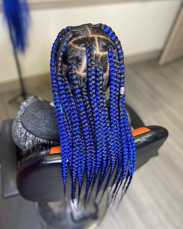 Chunky Blue Knotless Braids - A woman inside a salon