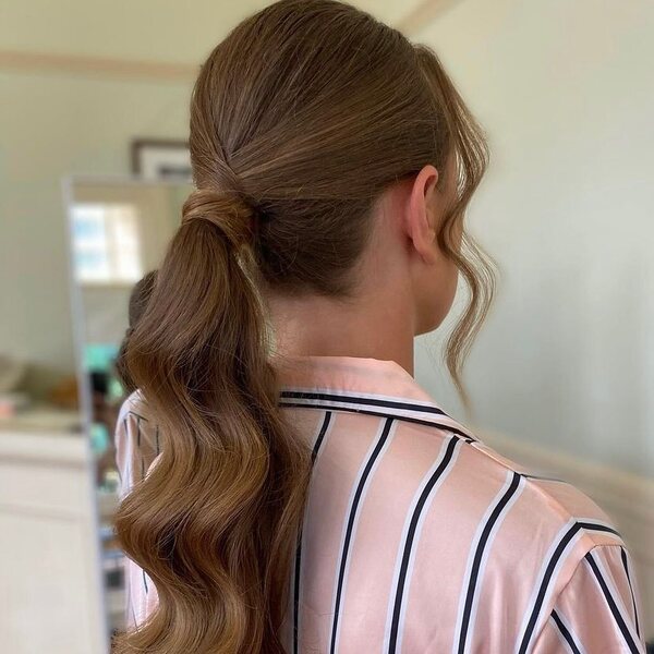 Classic Ponytail with Hair Extensions - A woman wearing a stripe blouse