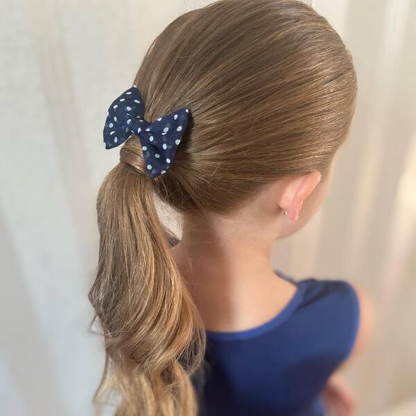 Classic Hairdos with Ribbon - A woman wearing a blue dress