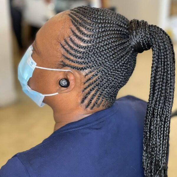 Cornrow Ponytail Updo Braid - A woman with blue surgical facemask wearing a blue shirt