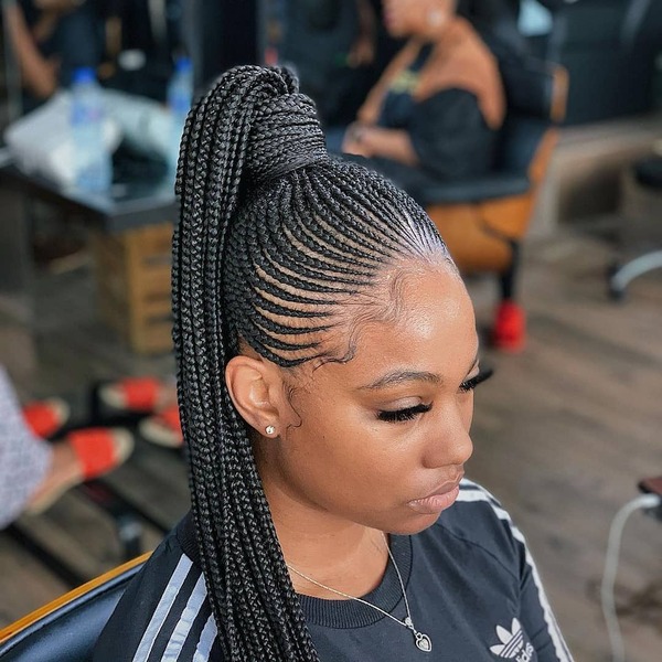 Cornrow Updo Ponytail Braid with Extension - A woman wearing a adidas shirt