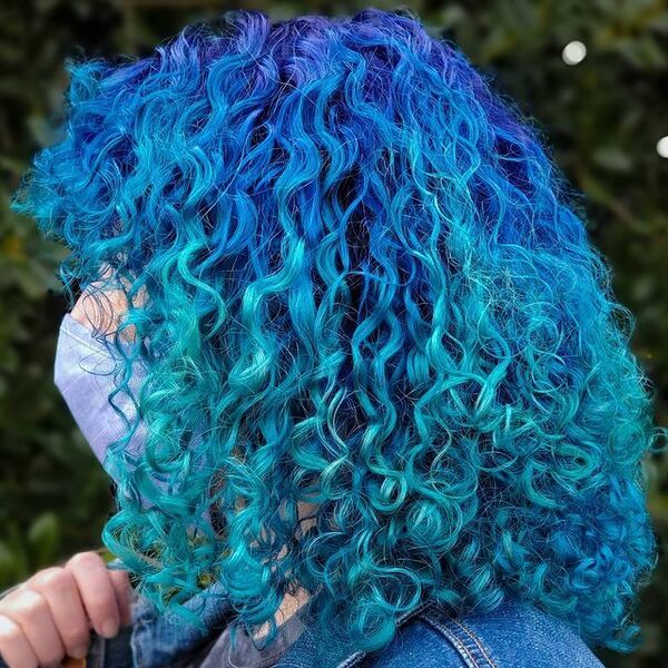 Cosmic Blue Afro Hairstyle - a woman in a side view