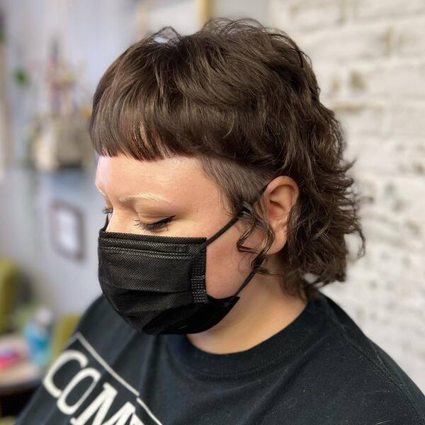 Curly Baby Shaggy Mullet Hairstyle - a woman wearing a black face mask