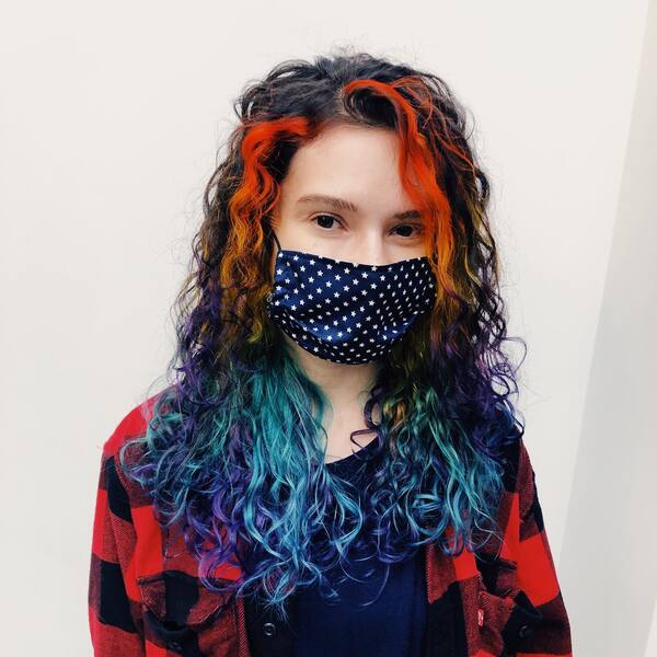Curly Celeste Hair Color - a woman wearing a face mask