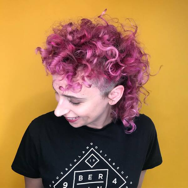 Curly Mullet With Pink & Purple Tones - a woman wearing a black t-shirt