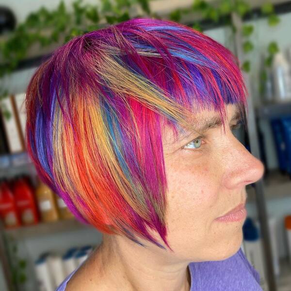 Fabulous Rainbow Hair Color - A woman wearing a purple shirt