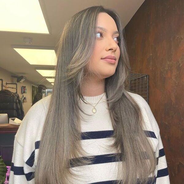 Feather Cut for Long Hair in Ash Blonde - A woman wearing a stripe shirt