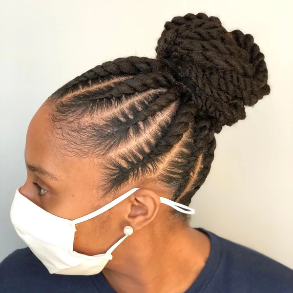 Twelve Feed In With Flat Twists Middle Bun- a woman wearing a white face mask