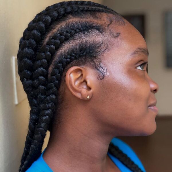 Flawless Waist Length African Cornrows Hairstyle - A woman wearing a small earrings