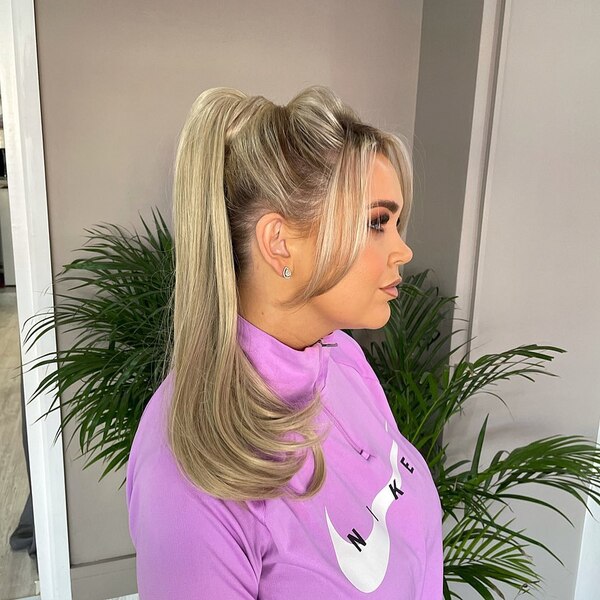 Flicky Ponytail Updo with Bangs - A woman wearing a purple nike sweater