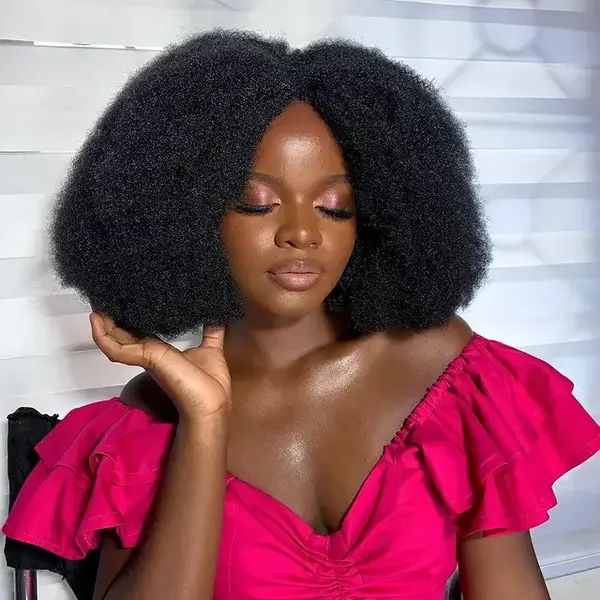 Fluffy Afro Hairstyle - a woman wearing a pink dress