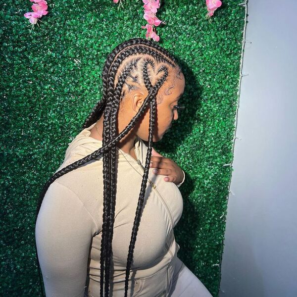 Freestyle Cornrows Braid with Heart - A woman wearing a cream jacket