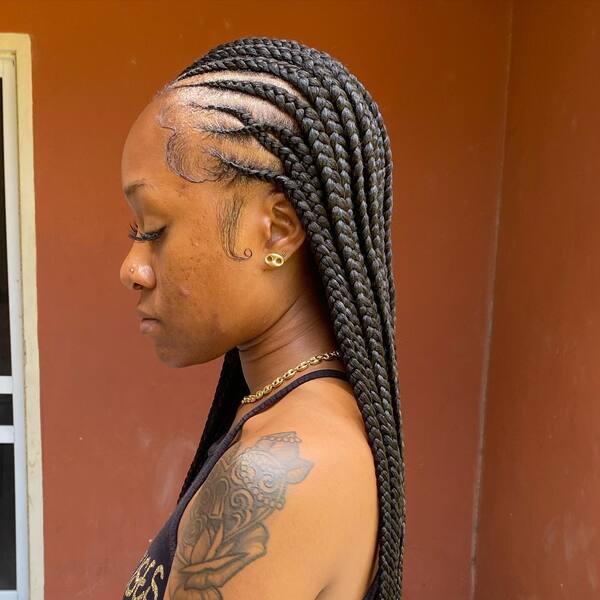 Fulani Cornrows Braid - A woman with tattoo wearing a black sleecveless top
