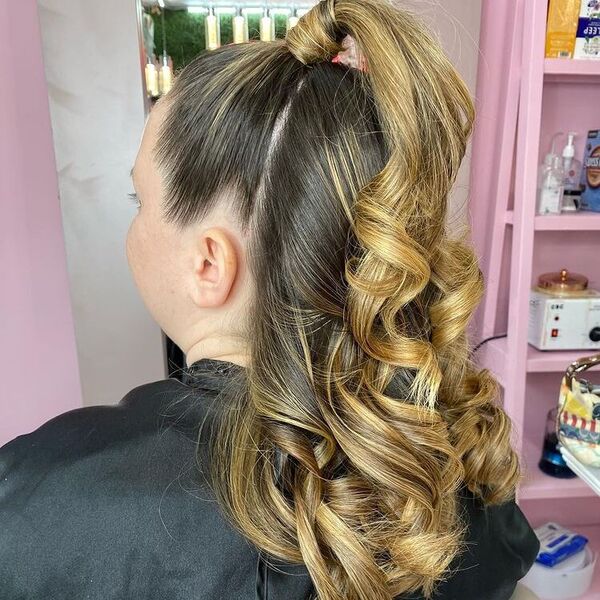 Half Up Half Down Curls Ponytail Updo - A woman with blonde hair wearing a black cape