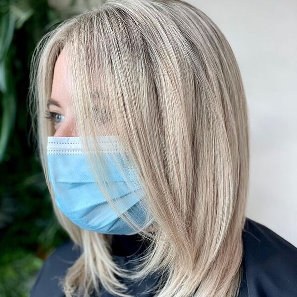 Healthy Hair  - A woman wearing a surgical facemask