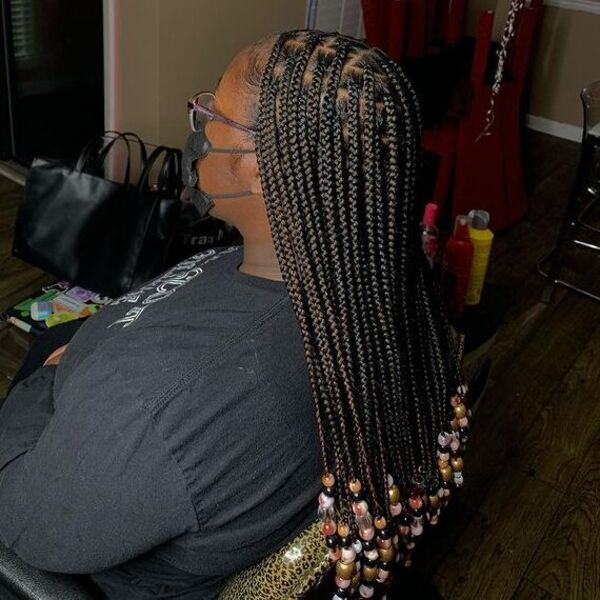 Knotless Braids with Beads - A woman with eyeglasses wearing a black facemask and black sweater