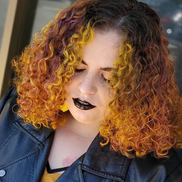 Lemon and Purple Curly Hair - a woman wearing a black jacket