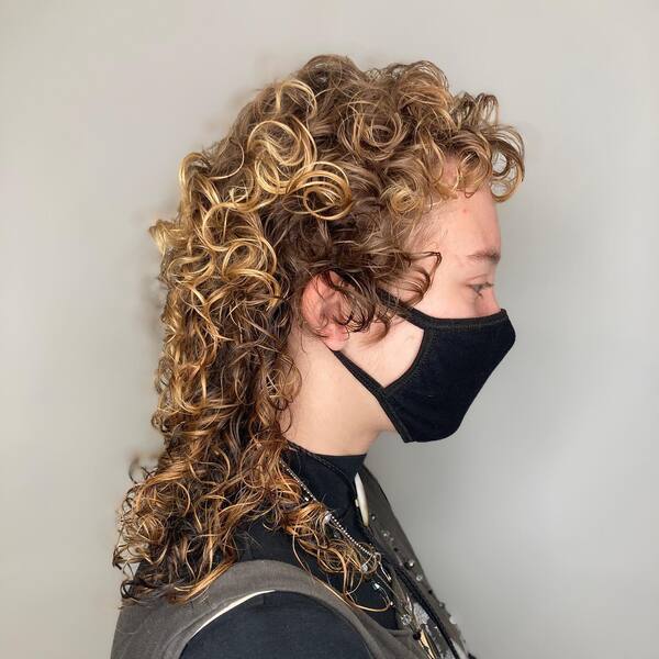 Long Golden Mullet Curls - a woman in a side view wearing a face mask