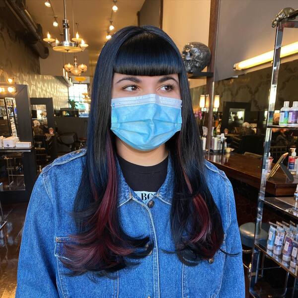 Long Hair and Blunt Bangs - a woman wearing a face mask