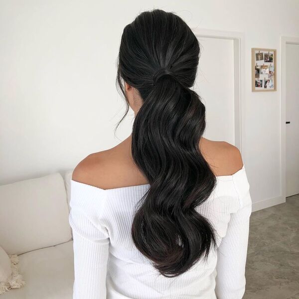 Long and Wavy Hairdos  - A woman wearing a white off shoulder longsleeve