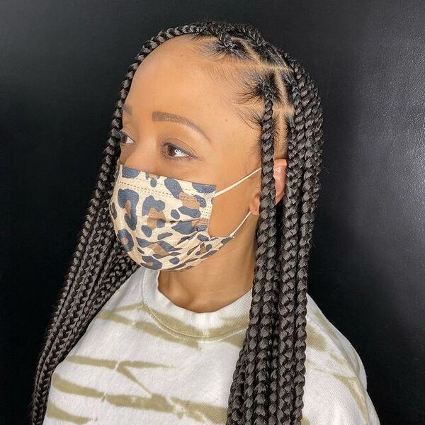 Medium Large Knotless Braid - A woman wearing a tiger facemask