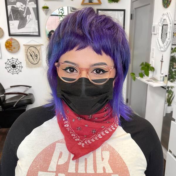 Mohawk with Faded Violet Hair Color - a woman wearing a black face mask