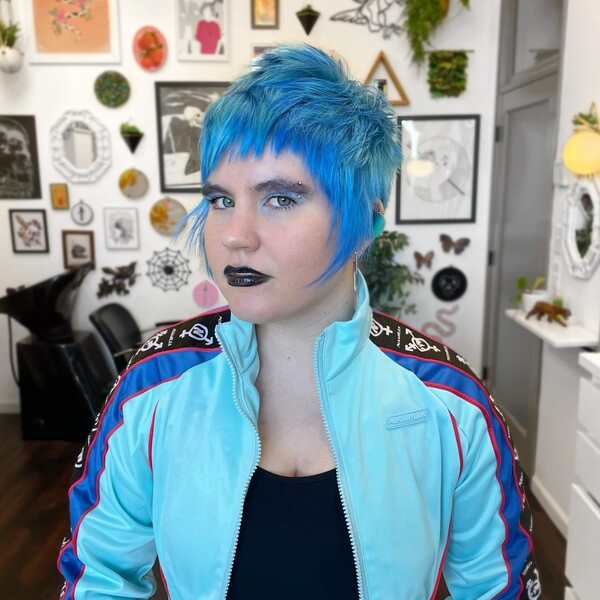 Mohawk with Icy Blue Bangs - a woman wearing a blue jacket