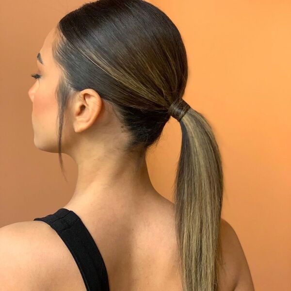 Ponytail with Thick Hair - A woman wearing a black sleeveless