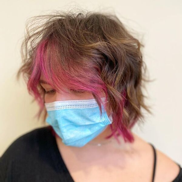Shaggy Bob with Pink Peek-A-Boo Bangs - a woman wearing a face mask