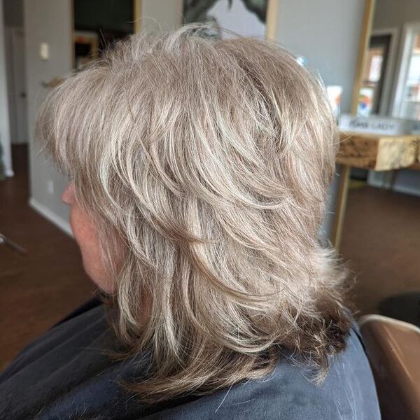 Shaggy Feathered Cut for Thin Hair - A woman inside a salon
