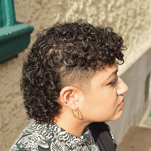 Short Top Curly Mullet Hairstyle - a woman in a side view