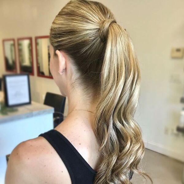 Simple Blonde Wavy Hair Ponytail - A woman wearing a black sleeveless top