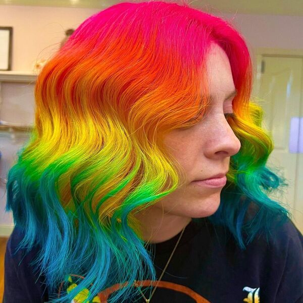 Light and Blunt Rainbow Wavy Hair - A woman wearing a black printed shirt