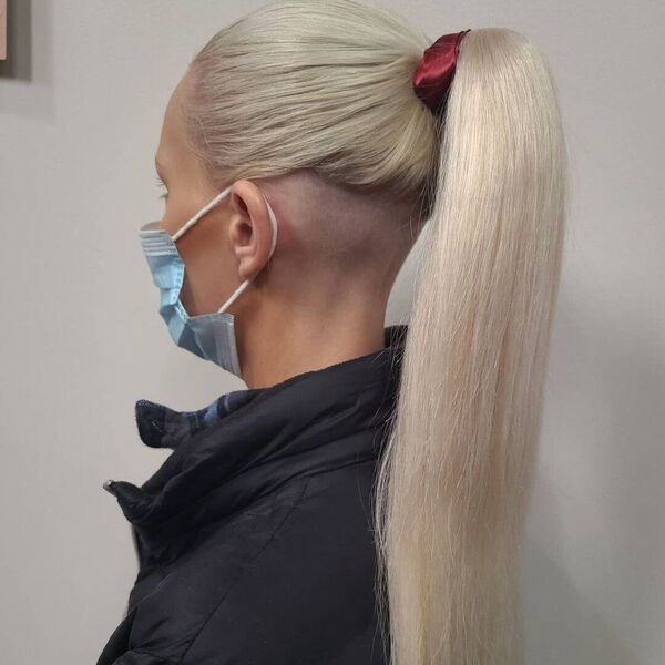Sleek & Edgy Ponytail Updo - A woman wearing a facemask