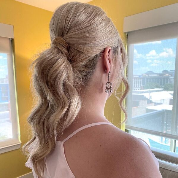 Sleek Smooth and Voluminous Ponytail Updo - A woman wearing a white sexy top