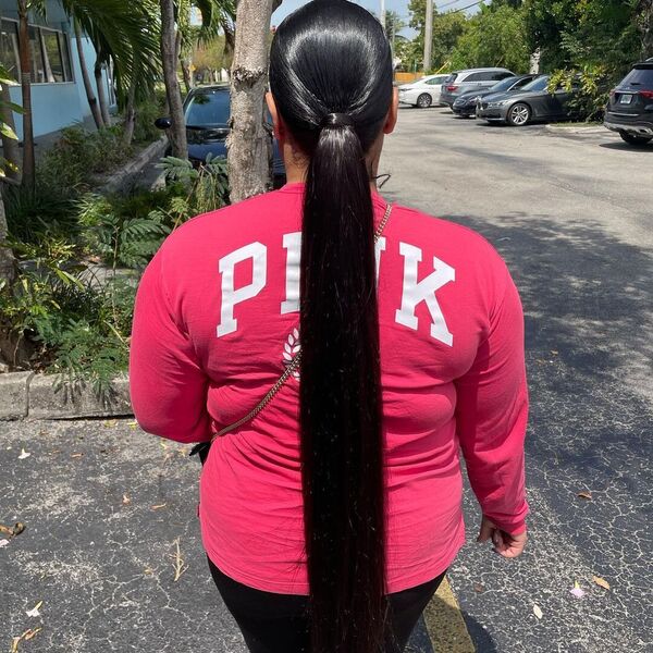 Sleek and Classic Ponytail with Bundles - A woman wearing a pink longsleeve