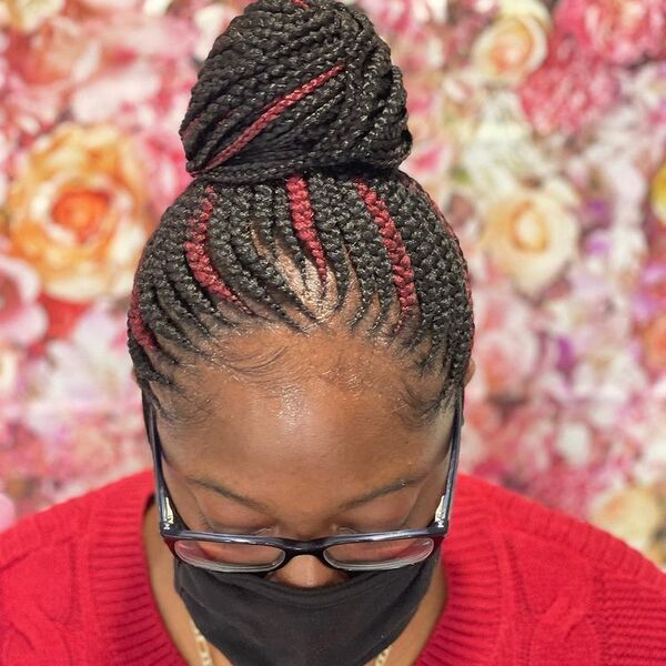 Small Feed In African Cornrow Braid Hairstyles with Bun - A woman wearing a eyeglasses