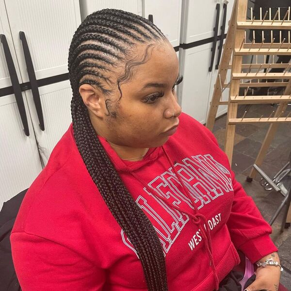 Small Feed In African Cornrow Braid Hairstyles - A woman wearing a red hooded jacket