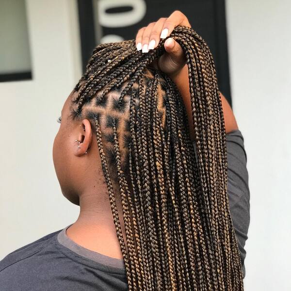Small Knotless Braids with Color Blend - A woman wearing a faded black longsleeve