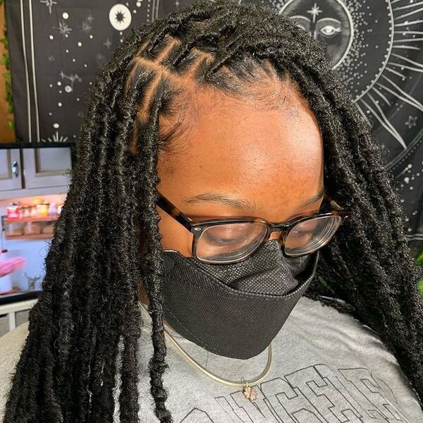 Small Soft Locs Knotless Braid - A woman wearing a eyeglasses and black facemask