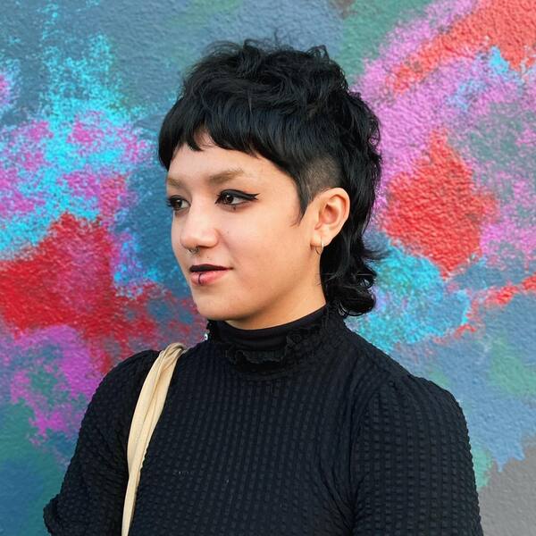 Soft & Edgy Curly Mullet - a woman in wearing a black turtle neck