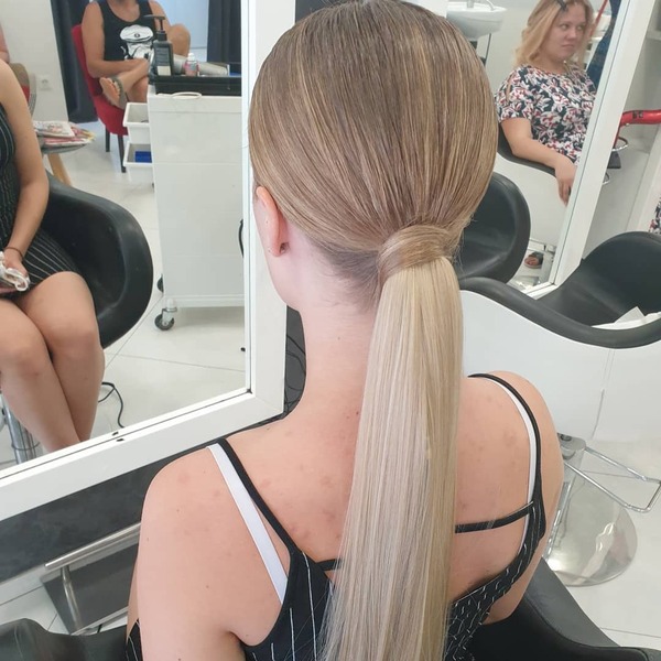 Straight and Wrap Ponytail with Blonde Balayage - A woman inside a salon