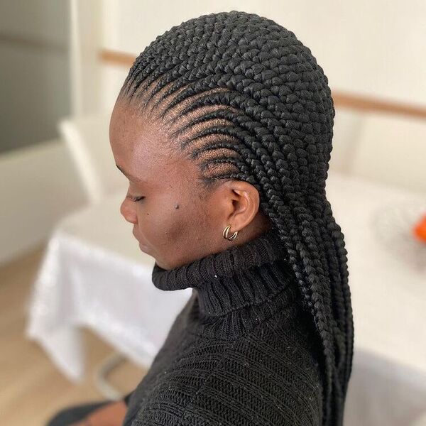 Stunning Cornrows Look - A woman wearing a black turtle neck sweater