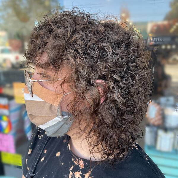 super curly hidden mullet - a woman in a side view
