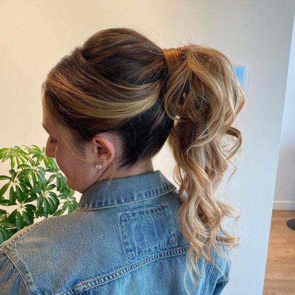 The Classic Wedding Ponytail Updo - A woman wearing a blue denim jacket