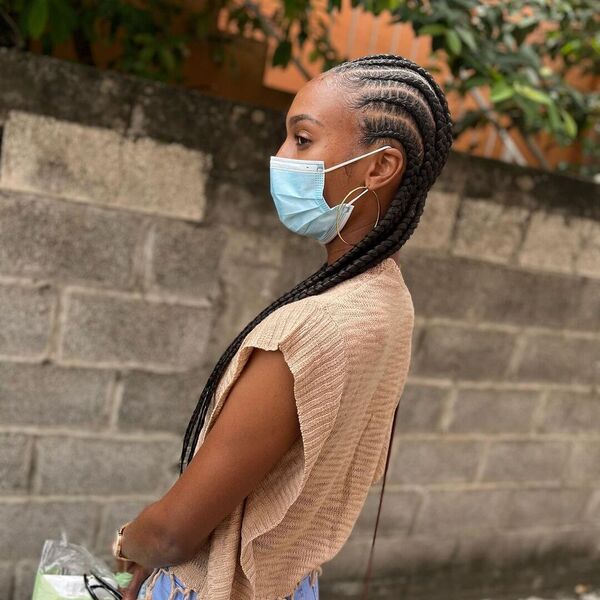 Tresses Invisibles African Cornrow Braid - A woman with blue surgical facemask wearing a brown off shoulder blouse